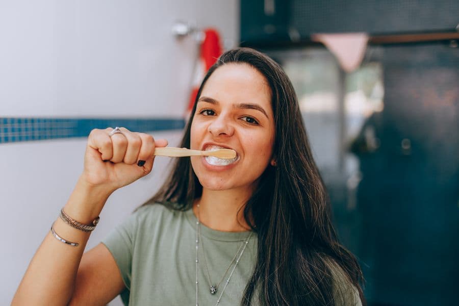 A woman brushing her teeth at home