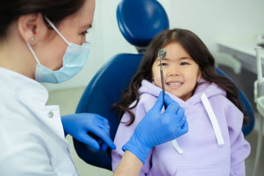 A friendly dentist with a smiling young patient