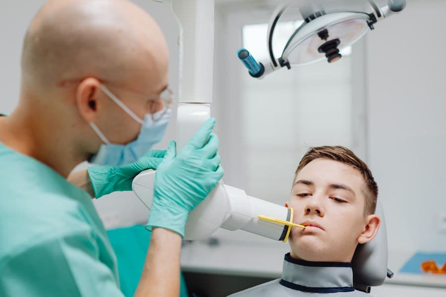 A patient having a dental X-ray taken in the clinic